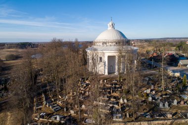 Holy Trinity Church in Suderve, Vilnius district, Lithuania. Cemetery in foreground.