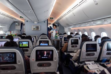Japan ANA Airlines and Boeing 787 Dreamliner interior with People And ANA Cabin Crew Members working for passengers.