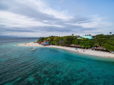 White Beach Moalboal in Cebu, Palawan, Philippines. Boat and Ocean Water and Beach. Drone