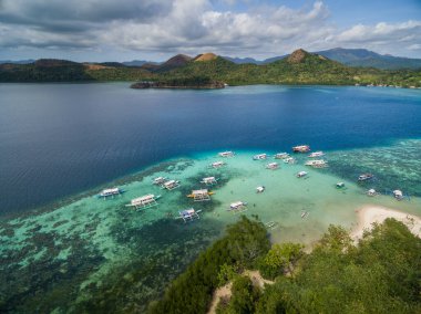 CYC beach in Coron, Palawan, Philippines. Corn Youth Club Beach. Mountain and Sea in background. Tour A. Drone