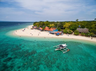 White Beach Moalboal in Cebu, Palawan, Philippines. Boat and Ocean Water and Beach. Drone