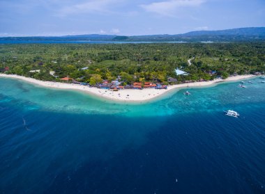 White Beach Moalboal in Cebu, Palawan, Philippines. Boat and Ocean Water and Beach. Drone