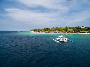 White Beach Moalboal in Cebu, Palawan, Philippines. Boat and Ocean Water and Beach. Drone