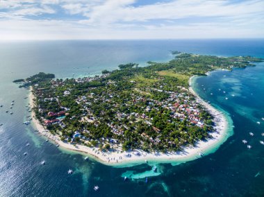 Sunny Day in Malapascua Island in Visayan Sea, One of Cebu Island in Philippines. Blue Sea water and Boats. Bounty Beach