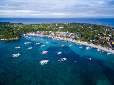 Sunny Day in Malapascua Island in Visayan Sea, One of Cebu Island in Philippines. Blue Sea water and Boats. Bounty Beach