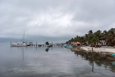 Caye Caulker Island in Caribbean Sea. Cloudy Morning And Calm Water in Pier. Belize. Caribbean Island