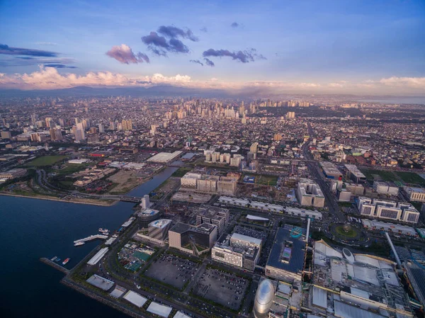 Manila Cityscape in Philippines. Blue Sky and Sunset Light. Pier in Foreground. Drone