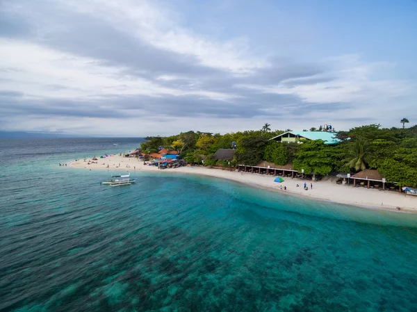 White Beach Moalboal in Cebu, Palawan, Philippines. Boat and Ocean Water and Beach. Drone