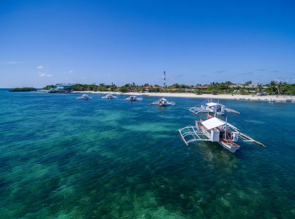 stock image Sunny Day in Malapascua Island in Visayan Sea, One of Cebu Island in Philippines. Blue Sea water and Boats in Background