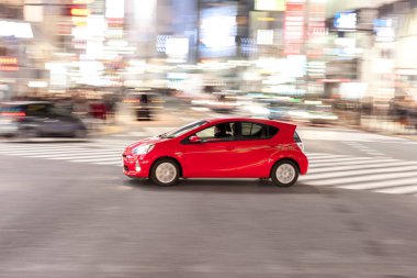 Shibuya District in Tokyo. Famous and busiest intersection in the world, Japan. Shibuya Crossing. Blurry Panning Black Taxi