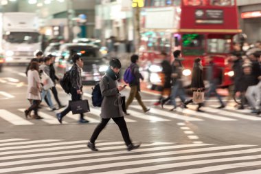 Shibuya District in Tokyo. Famous and busiest intersection in the world, Japan. Shibuya Crossing. Blurry Panning Black Taxi