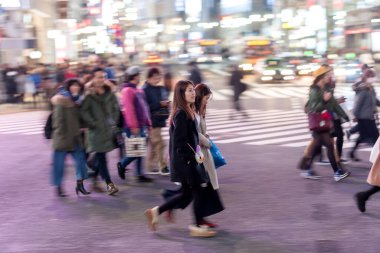 Shibuya District in Tokyo. Famous and busiest intersection in the world, Japan. Shibuya Crossing. Blurry Panning Black Taxi