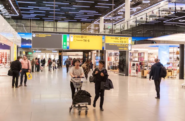 stock image AMSTERDAM, NETHERLAND - OCTOBER 18, 2017: International Amsterdam Airport Schiphol Interior with Passengers. Departure Area with Duty Free Shops.