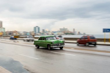 HAVANA, CUBA - 21 Ekim 2017: Havana, Küba 'daki eski araba. Retro Araç genellikle yerel halk ve turistler için bir taksi olarak kullanılır. Arka planda Karayip Denizi. Tarayıcı Yeşil Renkli Araba