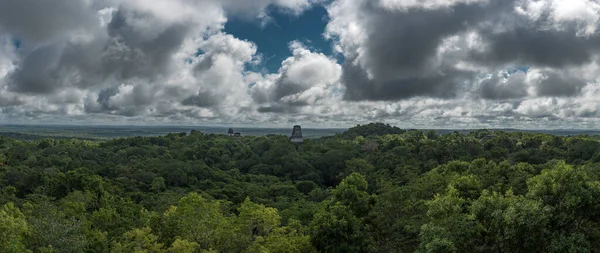 stock image People are sitting on Pyramid and the Temple in Tikal Park. Sightseeing object in Guatemala with Mayan Temples and Ceremonial Ruins. Tikal is an ancient Mayan Citadel in the Rainforests of Northern Guatemala.