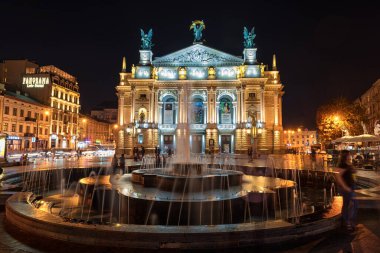 LVIV, UKRAINE - EPTEMBER 08, 2016: Lviv Ulusal Opera ve bale Akademik Tiyatrosu Solomiya Krushelnytska 'nın adını aldı. Uzun pozlama. Fountain 'in gece fotoğraf çekimi. Bulanık İnsanlar.