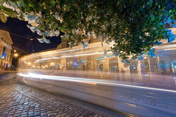 stock image LVIV, UKRAINE - SEPTEMBER 12, 2016: Lviv City and Lviv Old Town With People. Moving Tram. Blurry People because of Long Exposure.