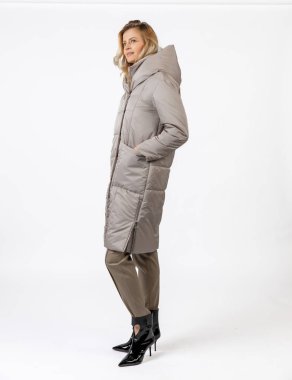 Sıcak kışlık palto giymiş zarif bir kadın şık bir resmi kıyafet giymiş, kendine güveni olmayan bir yüz ifadesi sergiliyor. Şık kış kıyafetleri ve günlük cazibe için ideal bir temsil..