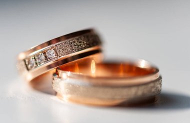 Karmaşık bir şekilde tasarlanmış elmas yüzükler gül altın ve gümüşle süslenmiş lüks ve bağlılık göstergesi. Karmaşık detaylar aşkı, güzelliği ve zamansızlığı vurgular.