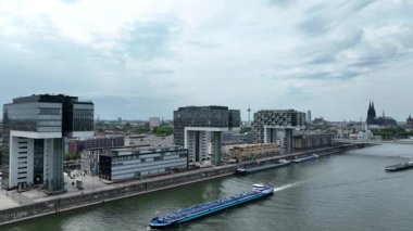 Office Buildings, Zollhafen district at Rhine river Cologne, Germany. Ship in the river. Drone