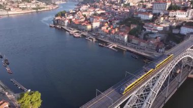 Dom Luis I Bridge and Morning Metro Train. Porto City, Portugal. Drone, 4k