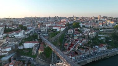 Colorful view at old town Porto at sunset, Portugal with bridge Ponte Dom Luis over Douro river. Drone, 4k