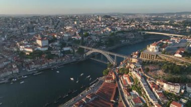 Douro river, Ribeira and Dom Luis I or Luiz I iron bridge in the sunny sunset Porto City, Portugal. Drone, 4k