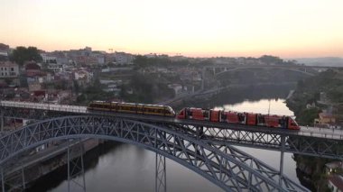 Early Morning Train on the Dom Luis I Bridge in Porto City, Portugal. Drone, 4k
