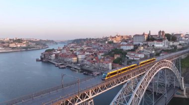Metro Trains on the Ponte Dom Luis I Brige in Porto, Portugal. Ribeira District in Background. Drone, 4k