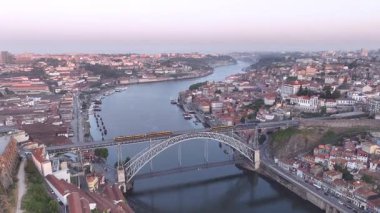Panorama of Douro river, Ribeira and Dom Luis I or Luiz I iron bridge in the sunny morning Porto, Portugal. Drone, 4k