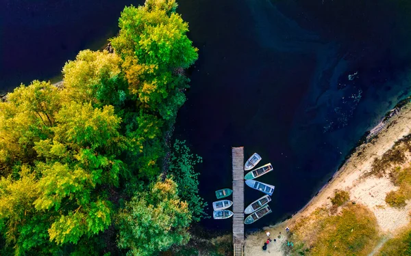 Aerial top down view of river pier with boats in summer at sunset. High quality photo