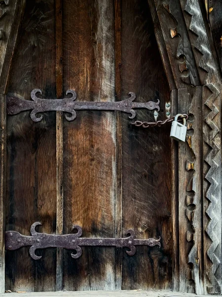 Locked in time: capturing the nostalgia of an old wooden woor with an aged lock. High quality photo