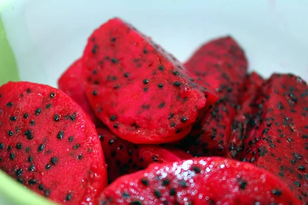 Dragon fruit with black seeds in a bowl. Close-up.