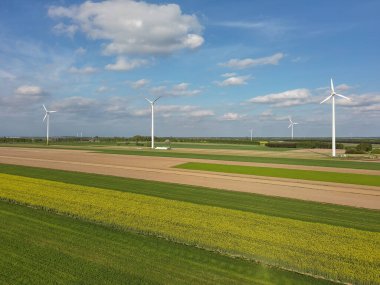 Bahar tarlaları ve elektrikli yel değirmenleri.