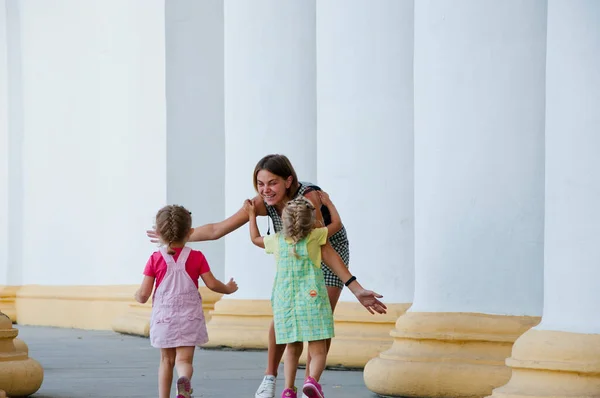 Stock image childhood and motherhood. bonding happiness. having fun together. mothers or childrens day. friendship of sisters girls. running to mom. mother and daughter children outdoor. happy lovely family day.