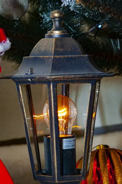 December holiday light bulb. Decorated Xmas lamp. Christmas lantern lamp. Merry Christmas. Happy Ney Year 2024. Xmas holiday celebration. New Year eve. Street lantern.
