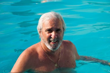 Havuzda yüzen son sınıf öğrencisi. Yaz tatili ve emeklilik. Yazın kaplıcada kıdemli adam..