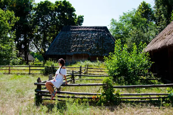 Woman outdoor. Ukrainian woman in summer village cottage. Ukraine folk authentic house. Thatched house in Ukrainian village. Woman in summer farm. Authentic Ukrainian architecture. Quaint farmhouses.
