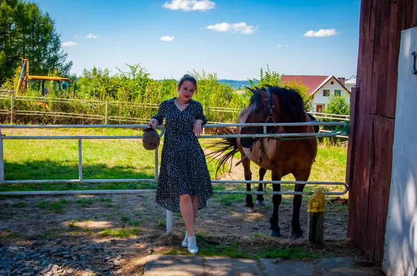 stock image Woman with horse in stable at countryside ranch. Girl horse rider in summer outdoor. Equestrian and horseback riding. Horse stallion equine with Hispanic woman girl. Countryside ranch. Dude ranch.