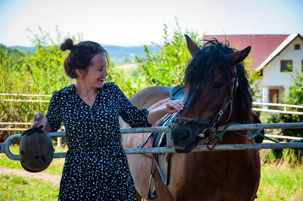 Stock image Woman with horse in stable at countryside ranch. Girl horse rider in summer outdoor. Equestrian and horseback riding. Horse stallion equine with Hispanic woman girl. Countryside ranch. Sport.