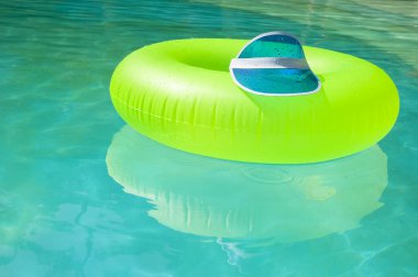 Bilardoda eğlence. Havuz kenarında şişme halka. Yaz tatili. Bilardoda dinleniyorum. Yaz tatili. Yüzme havuzunda şişme halka. Yüzen parlak halka ve şapka. Reklam..