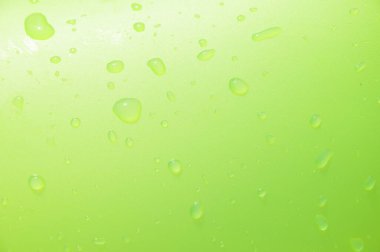 Havuz başında yaz tatili. Islak arka planın yeşil rengi. Havuzda yeşil şişme yüzüğe bir damla su. Su damlası olan yeşil arkaplan. Yüzme havuzunda şişme halka ıslandı. Yeşilin tonları.