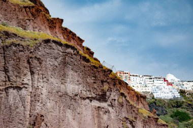 Volkanik dağlı Yunanistan. Cyclades Yunan takımadaları. Yunanistan 'ın Santorini kentindeki dağda inşa edilmiş volkanik kayalar. Seyahat güzergahı. Santorini adası volkanik kaya manzarası.