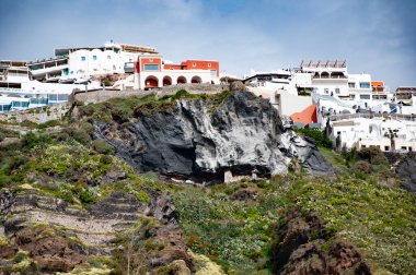 Yunanistan 'ın Santorini kentindeki dağda inşa edilmiş volkanik kayalar. Seyahat güzergahı. Santorini adası volkanik kaya manzarası. Volkanik dağlı Yunanistan. Cyclades Yunan takımadası.