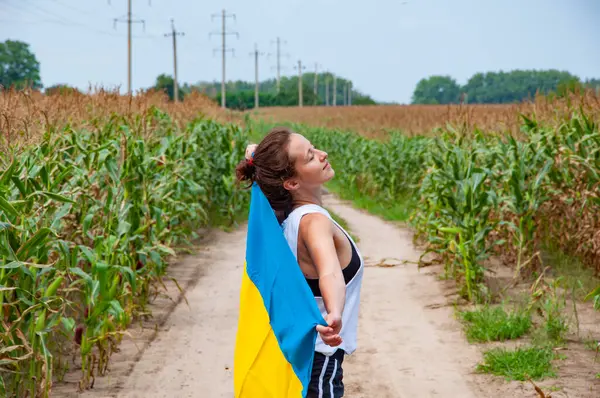 Bağımsızlık Günü. Vatanseverlik sembolü. Vatanseverlik. Ukrayna bayrağı anma günü veya 24 Ağustos. Tarlada Ukrayna bayrağıyla kaplanmış bir kız. Ukrayna bayrağı. Ulusal bayrak vatansever kız, hasat, hasat.