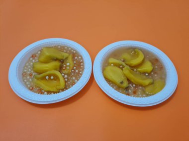 Olgun meyveler ve küçük tatlı toplarla dolu tatlı komposto.