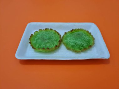 A market snack made from flour and other ingredients is called kue kucur green clipart