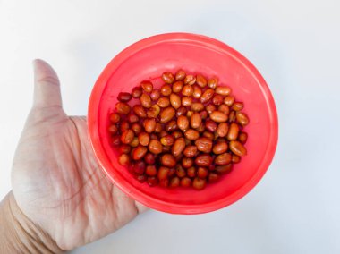 Kırmızı bir arka planda beyaz bir kabın içindeki yumuşak süt turtası.