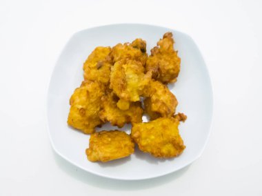 Beyaz bir kabın içinde abur cubur ya da kızarmış mısır omleti.