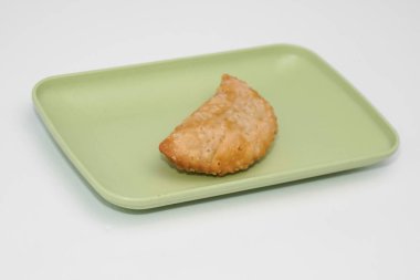 Pazar atıştırmalığına pastel kek deniyor. Beyaz arka planlı bir kabın içinde.